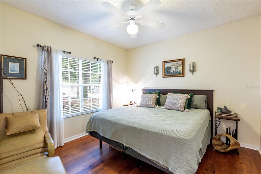 10000 Southwest 52nd Avenue, Unit 124 Gainesville, FL 32608 - Photo 17 of 33 a bedroom with a bed and wooden floor