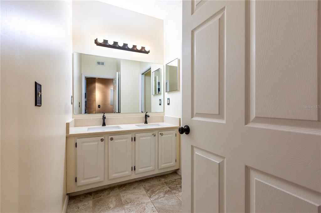 10000 Southwest 52nd Avenue, Unit 124 Gainesville, FL 32608 - Photo 19 of 33 a spacious bathroom with a double vanity sink and mirror