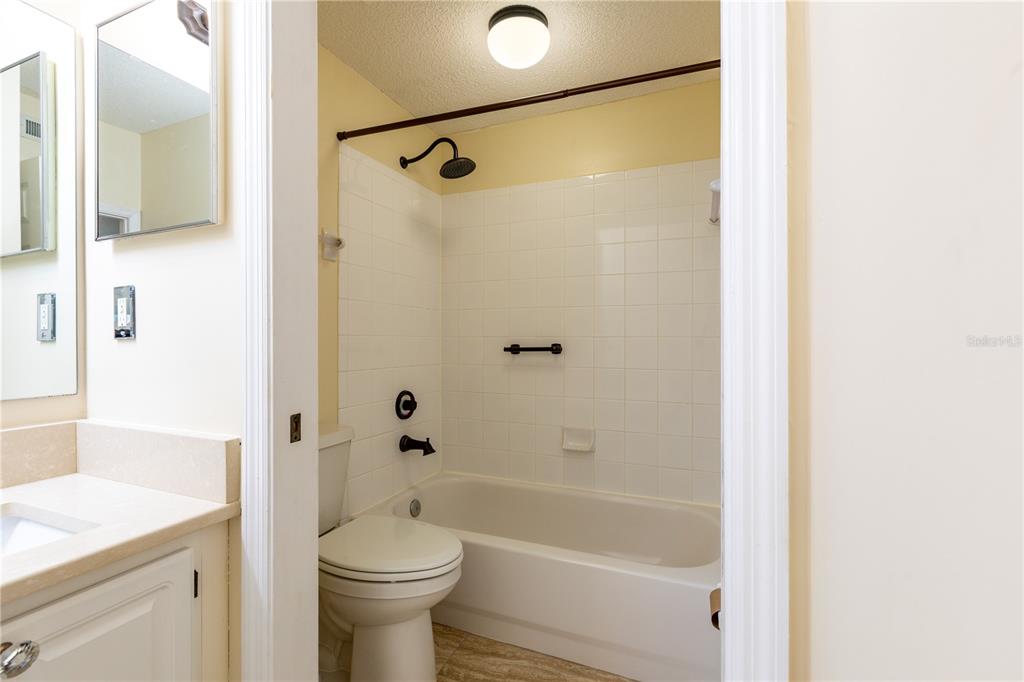 10000 Southwest 52nd Avenue, Unit 124 Gainesville, FL 32608 - Photo 20 of 33 a bathroom with a sink a toilet and shower