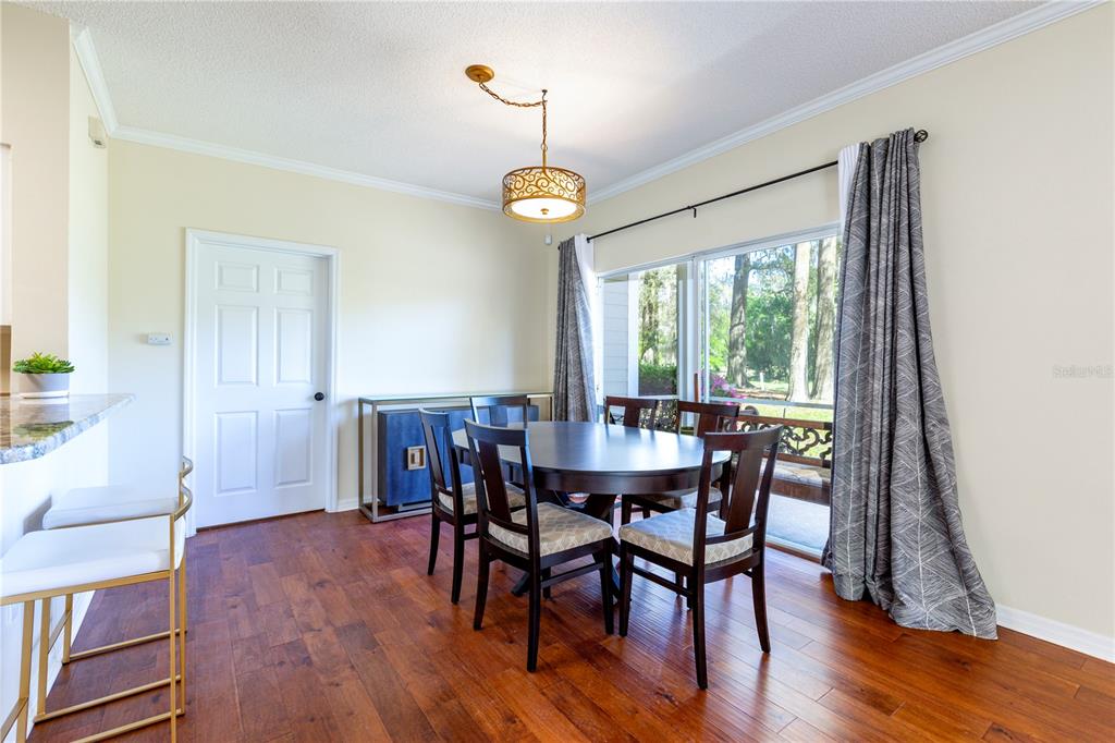 10000 Southwest 52nd Avenue, Unit 124 Gainesville, FL 32608 - Photo 27 of 33 a view of a dining room with furniture window and wooden floor