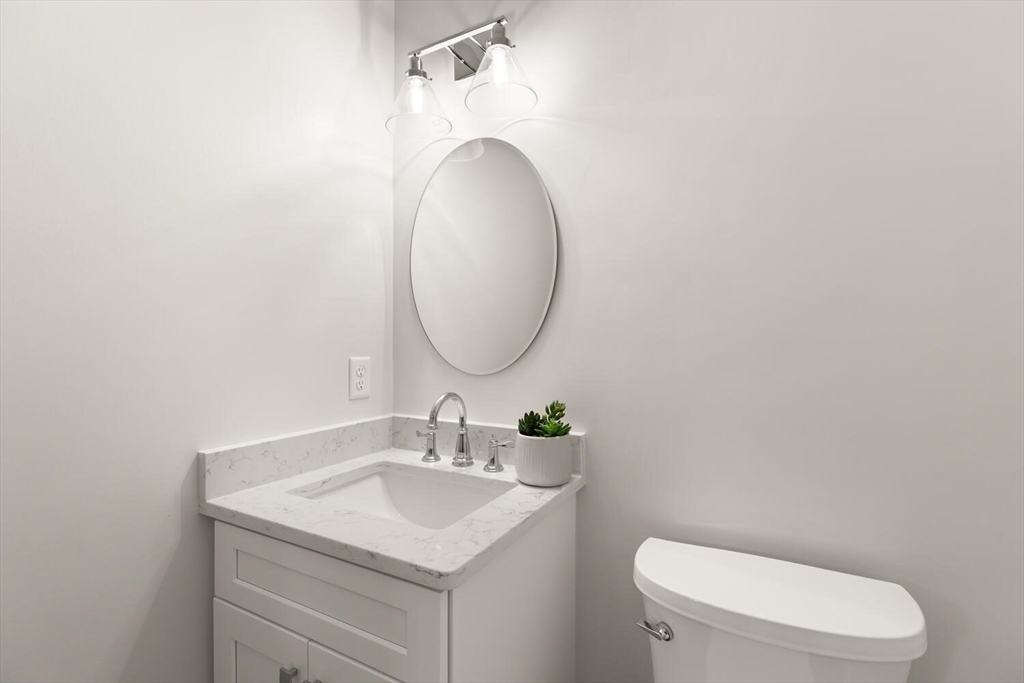 9 Barracks Road, Unit 9 Hudson, MA 01749 - Photo 12 of 16 a bathroom with a toilet sink and mirror