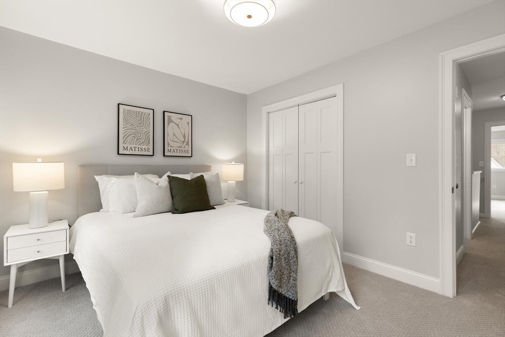 9 Barracks Road, Unit 9 Hudson, MA 01749 - Photo 9 of 16 a bedroom with a bed and a painting on the wall