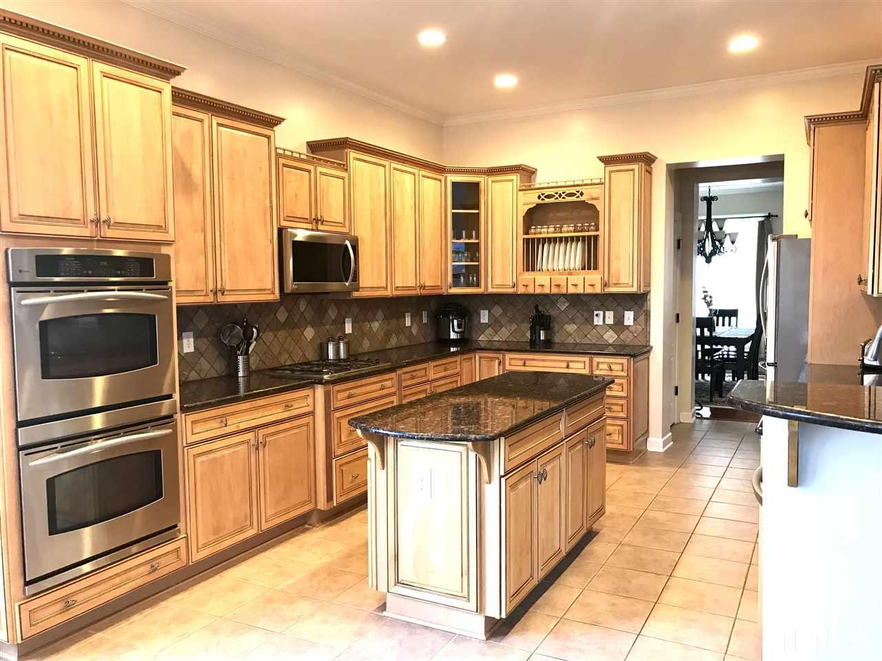2913 Elmfield Street Raleigh, NC 27614 - Photo 7 of 30 Gourmet Kitchen showcasing Gas Range, Stainless Steel Appliances, Custom Cabinetry and Double Ovens.
