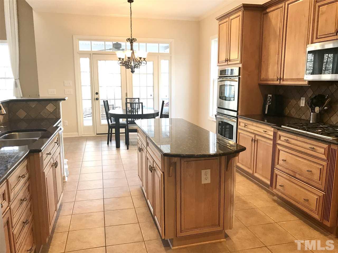 2913 Elmfield Street Raleigh, NC 27614 - Photo 8 of 30 Gourmet Kitchen with Breakfast Area leading to Enclosed Deck.