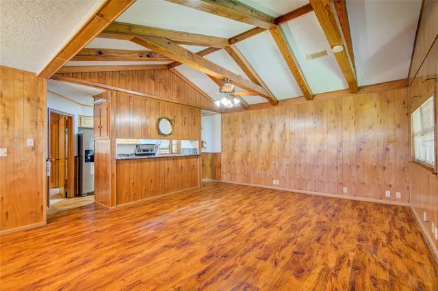 a view of a room with wooden floor