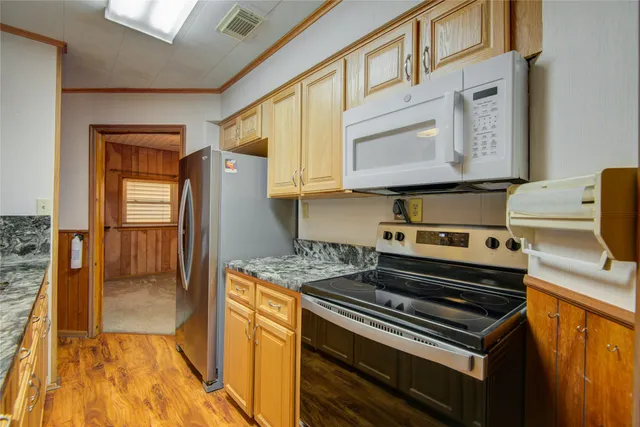 a kitchen with a stove and a refrigerator