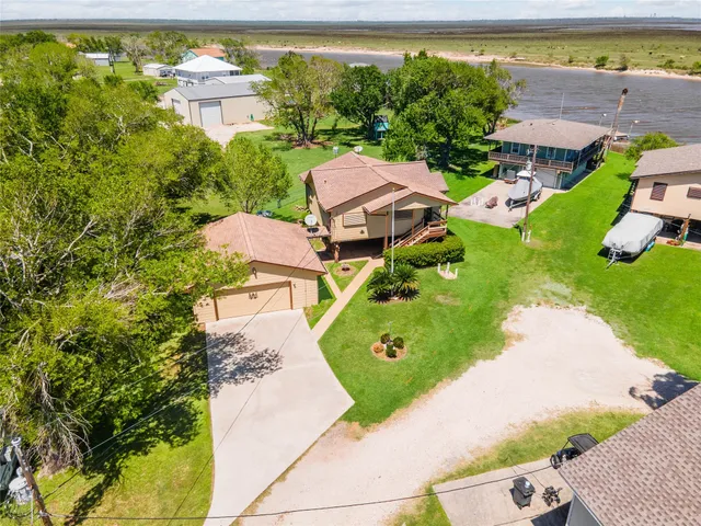an aerial view of a house with a yard basket ball court and outdoor seating
