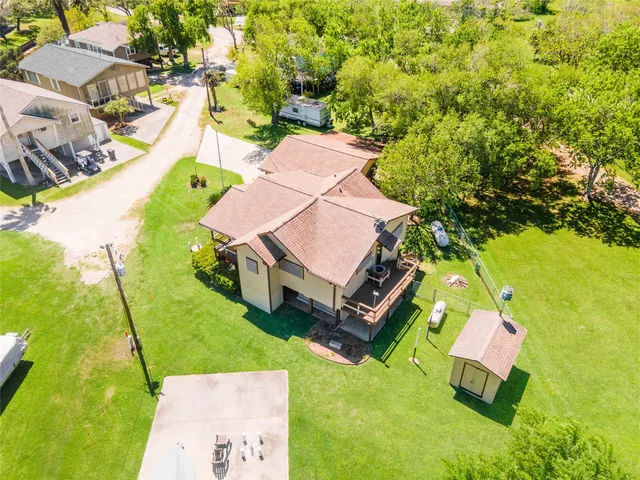 an aerial view of a house with a garden and swimming pool