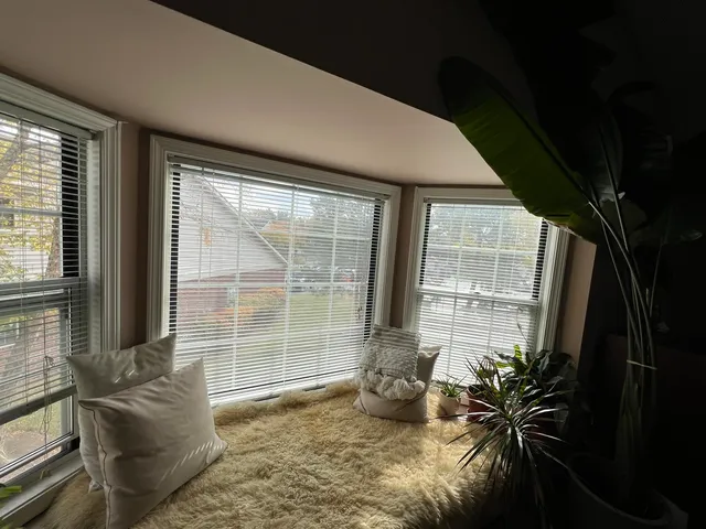 a room with bed and large windows