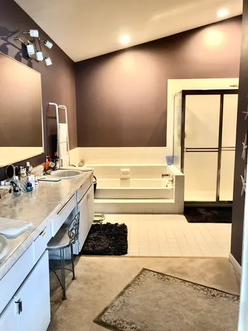 a bathroom with a sink vanity and a mirror