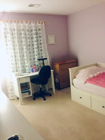 a bedroom with furniture and a window