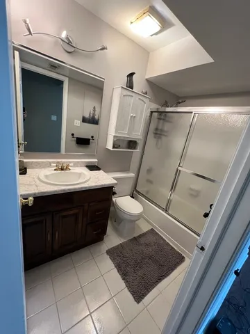 a room with a toilet a sink and mirror
