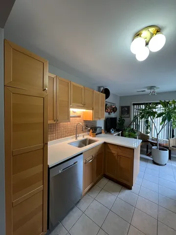 a kitchen with stainless steel appliances granite countertop a sink and a refrigerator