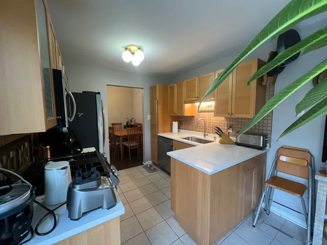 a kitchen with a sink appliances and cabinets