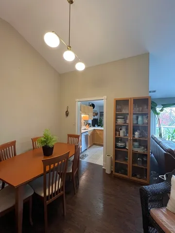 a view of a dining room with furniture and a chandelier