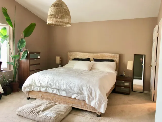 a bedroom with a bed and a chandelier