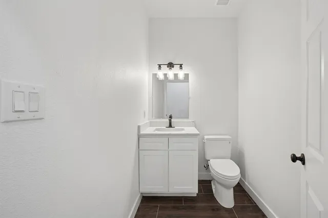a bathroom with a toilet a sink and mirror