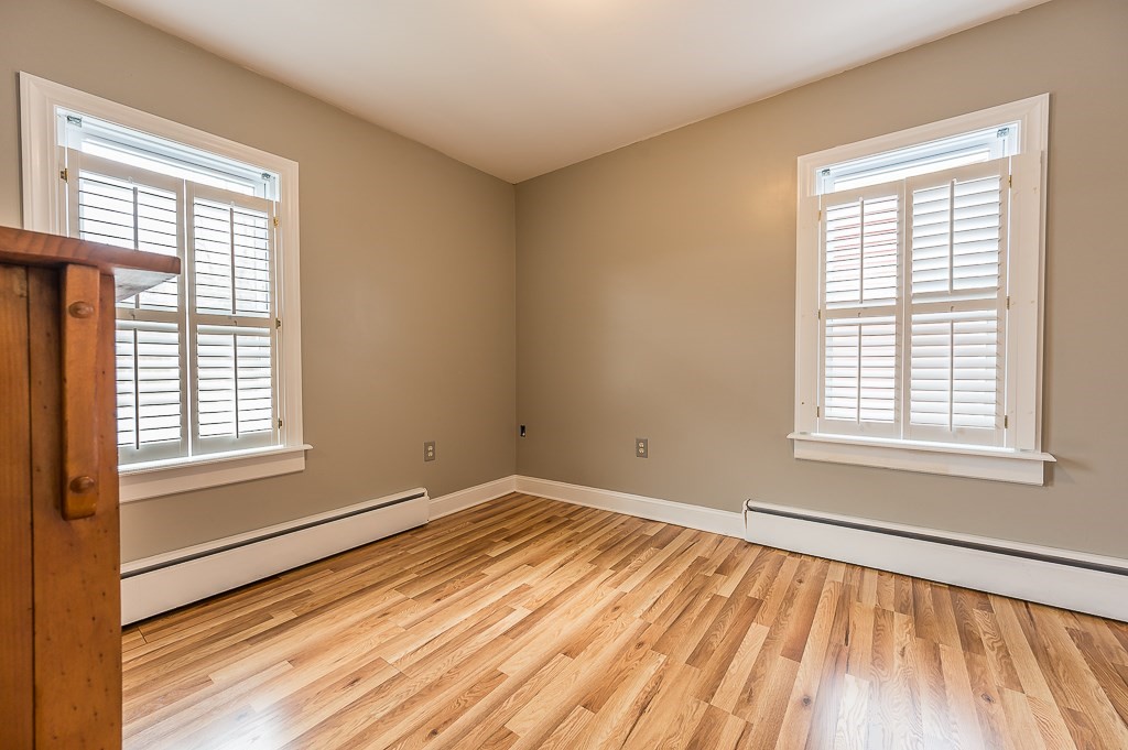 265 Main Street Sturbridge, MA 01566 - Photo 12 of 25 a view of an empty room with wooden floor and a window