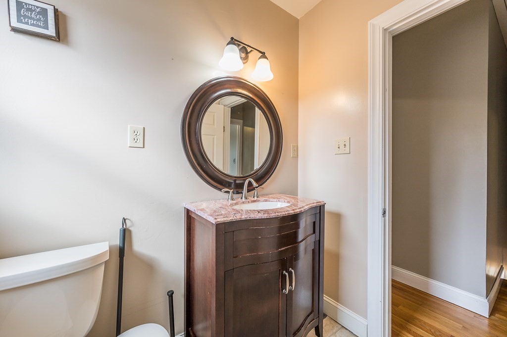 265 Main Street Sturbridge, MA 01566 - Photo 23 of 25 a bathroom with a toilet mirror vanity and a sink