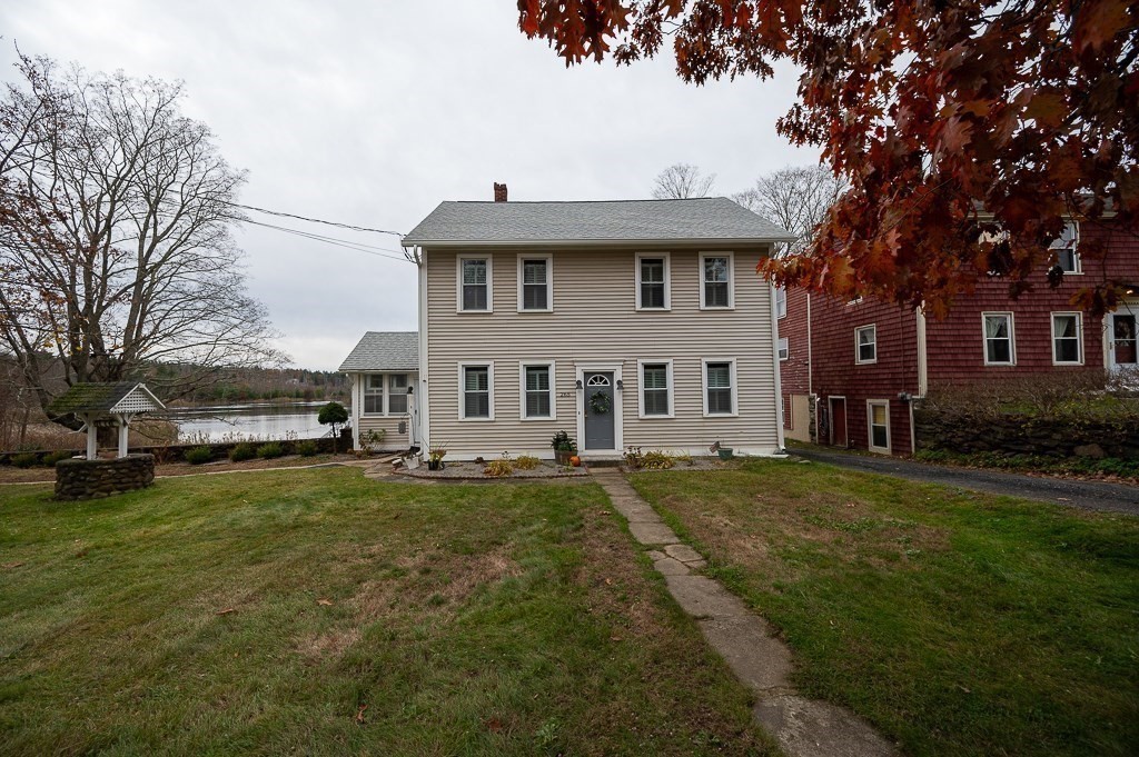 265 Main Street Sturbridge, MA 01566 - Photo 3 of 25 a view of a house with a large tree and a yard