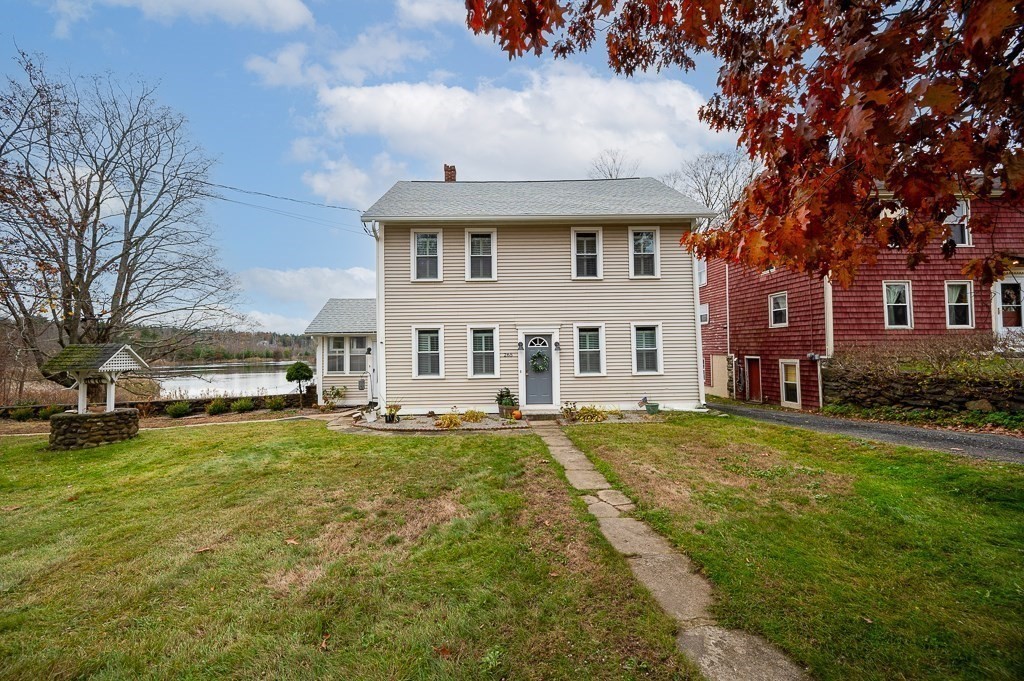 265 Main Street Sturbridge, MA 01566 - Photo 4 of 25 a view of a white house with a big yard and large tree