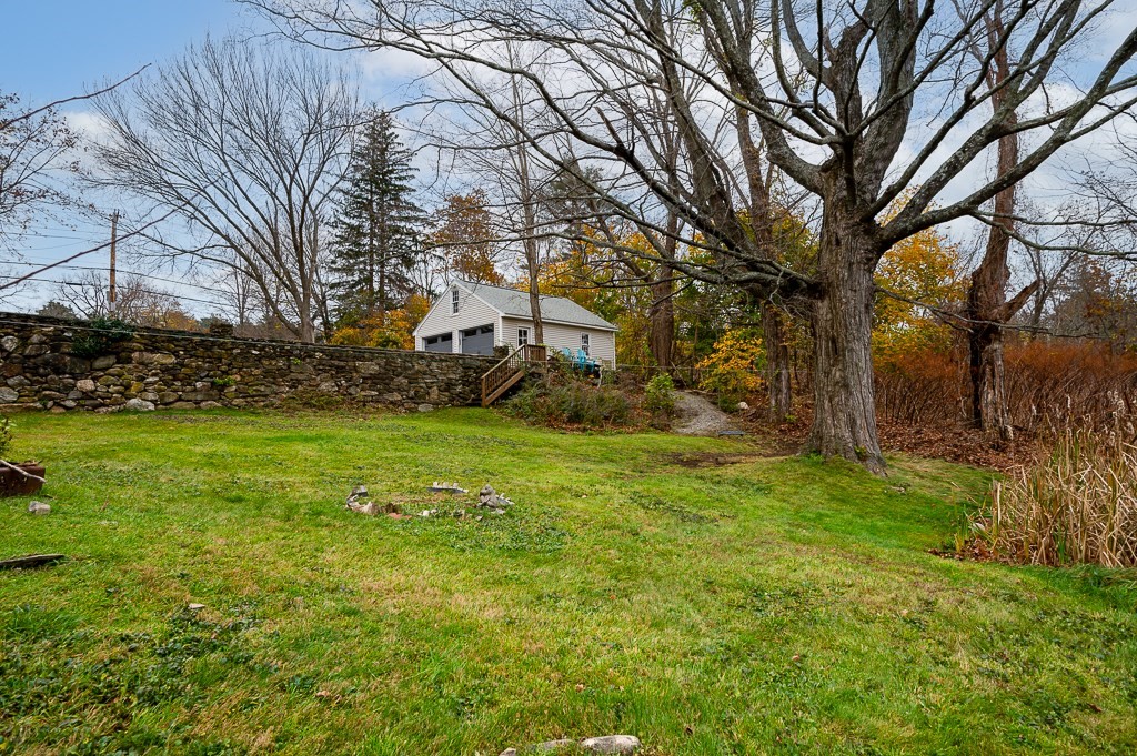 265 Main Street Sturbridge, MA 01566 - Photo 6 of 25 a view of a backyard with large trees