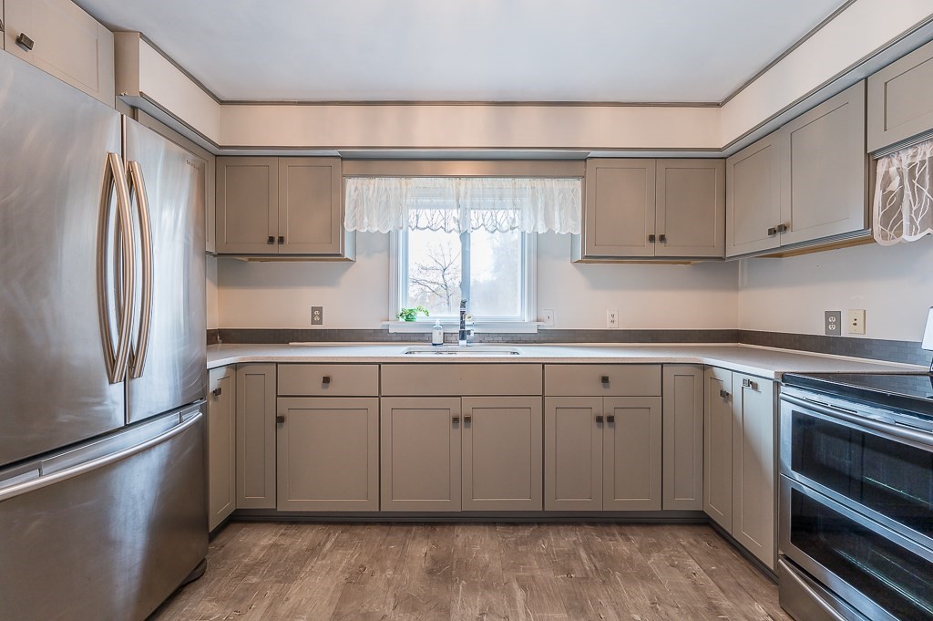 265 Main Street Sturbridge, MA 01566 - Photo 7 of 25 a kitchen with granite countertop a sink stainless steel appliances and cabinets