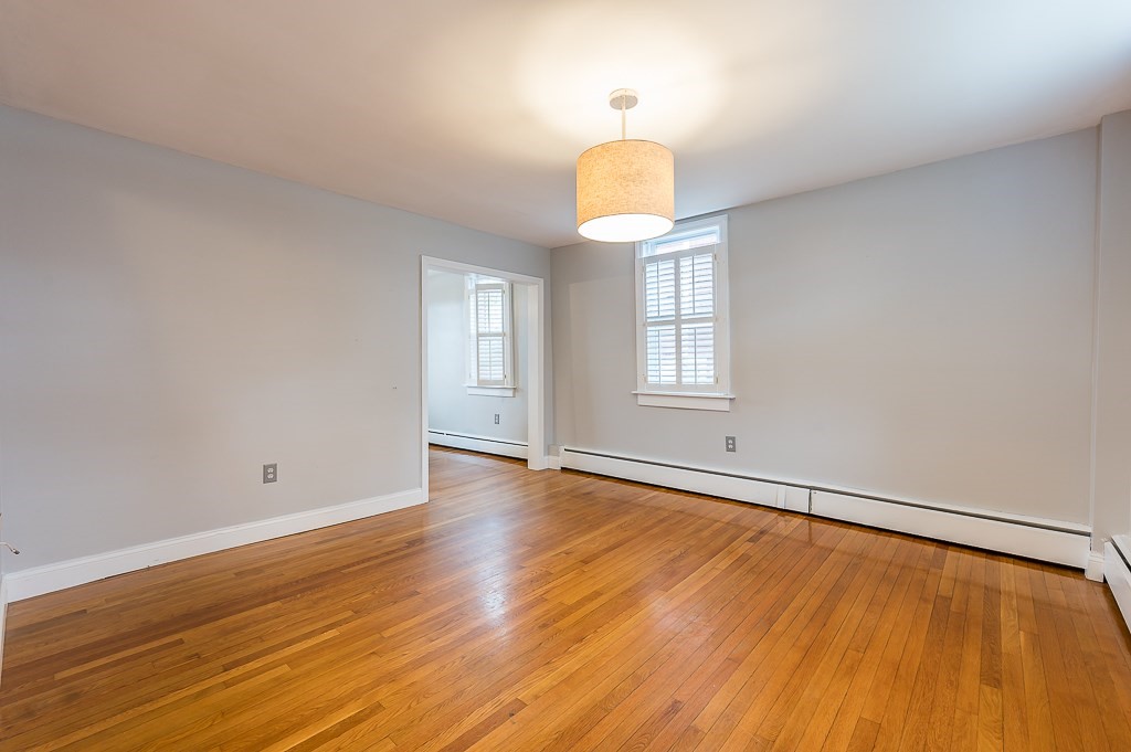 265 Main Street Sturbridge, MA 01566 - Photo 8 of 25 a view of an empty room with wooden floor and a window