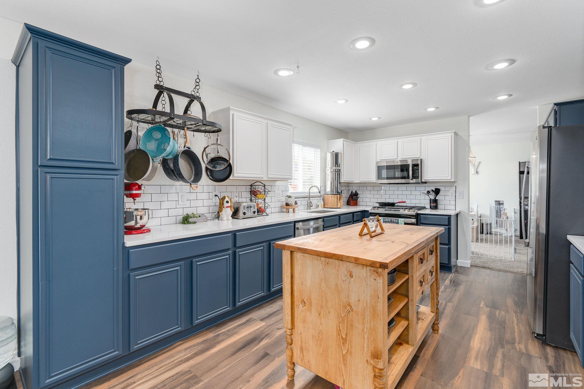 18198 Pin Oak Court Reno, NV 89508 - Photo 12 of 39 a kitchen with stainless steel appliances granite countertop a sink stove and refrigerator
