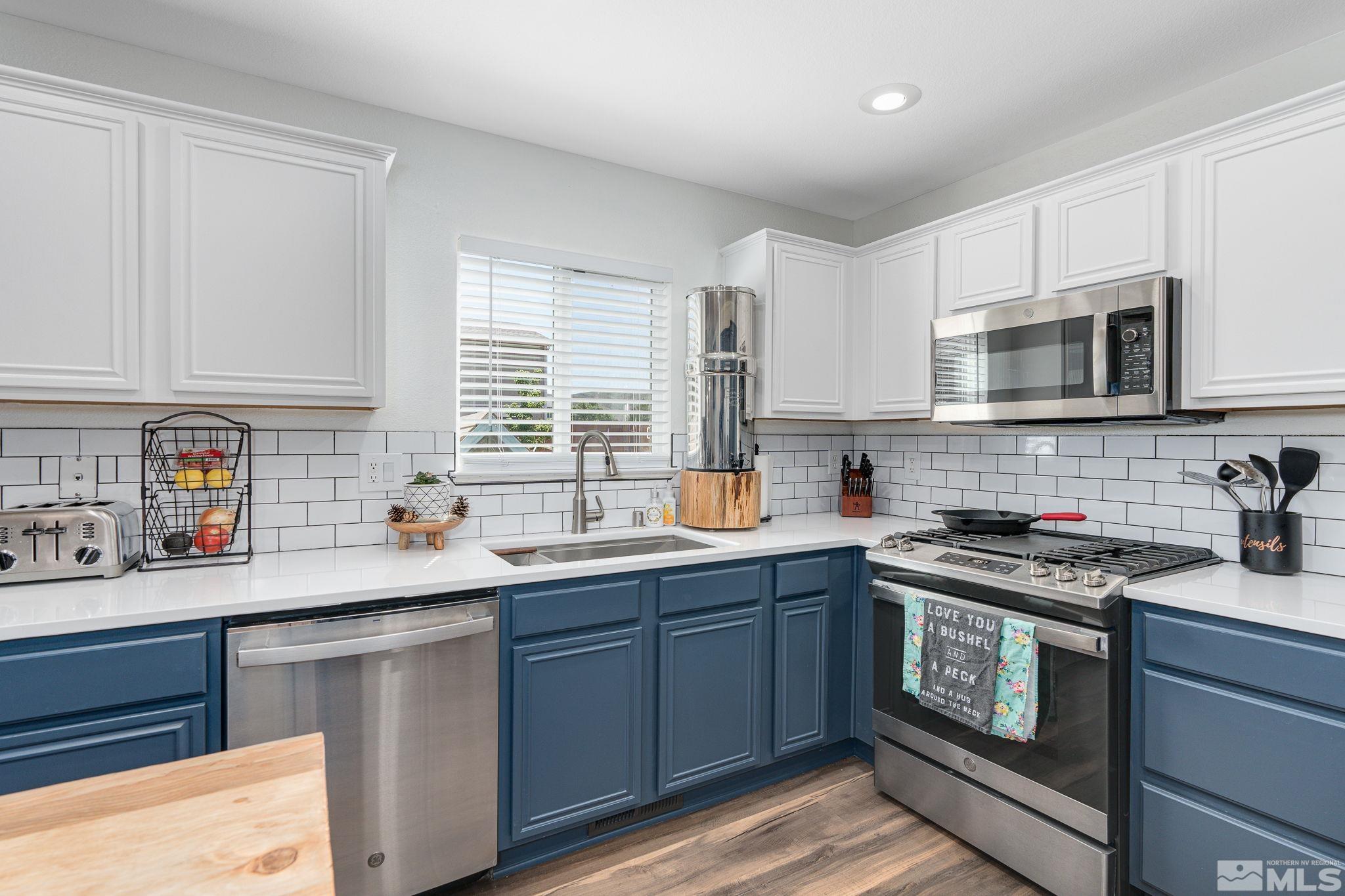 18198 Pin Oak Court Reno, NV 89508 - Photo 13 of 39 a kitchen with stainless steel appliances granite countertop a sink stove microwave and cabinets