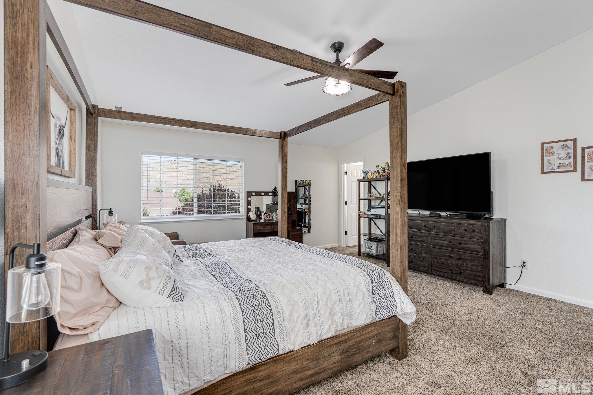 18198 Pin Oak Court Reno, NV 89508 - Photo 20 of 39 a bedroom with a bed and a flat screen tv