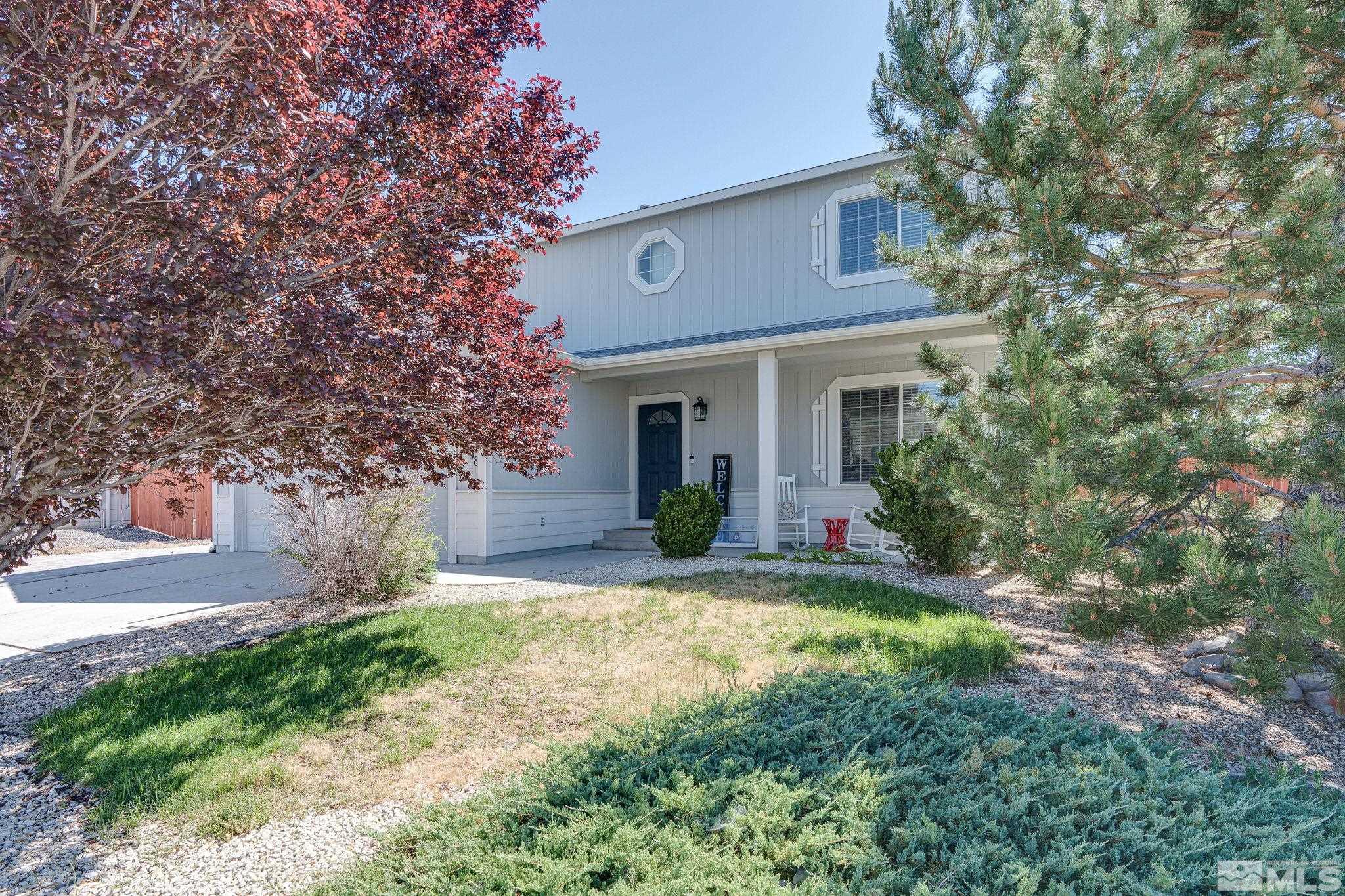 18198 Pin Oak Court Reno, NV 89508 - Photo 2 of 39 a front view of a house with a yard and garage
