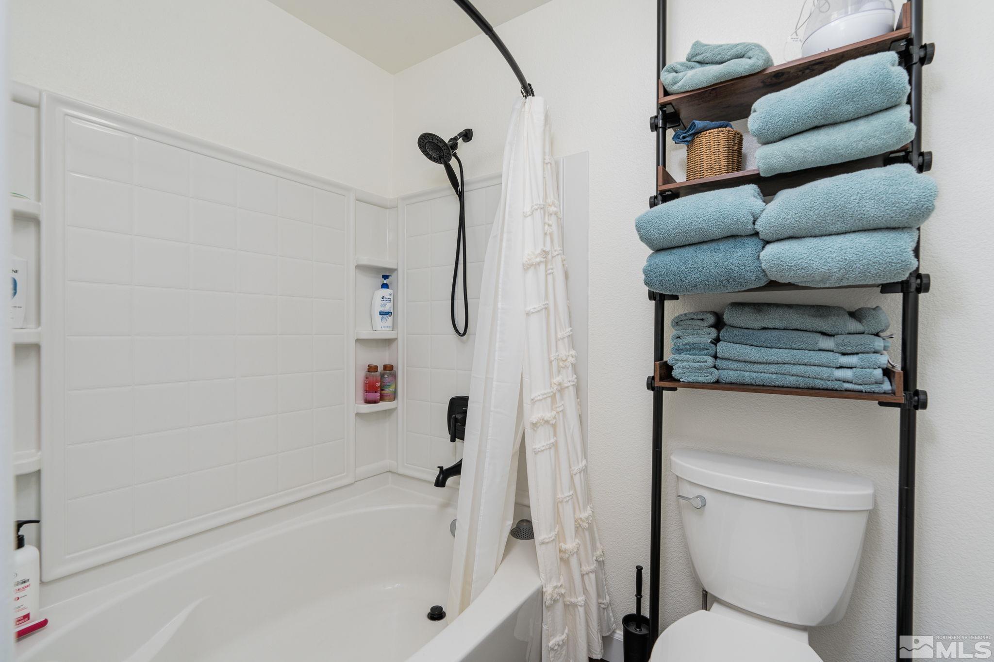 18198 Pin Oak Court Reno, NV 89508 - Photo 23 of 39 a bathroom with a toilet and a bathtub