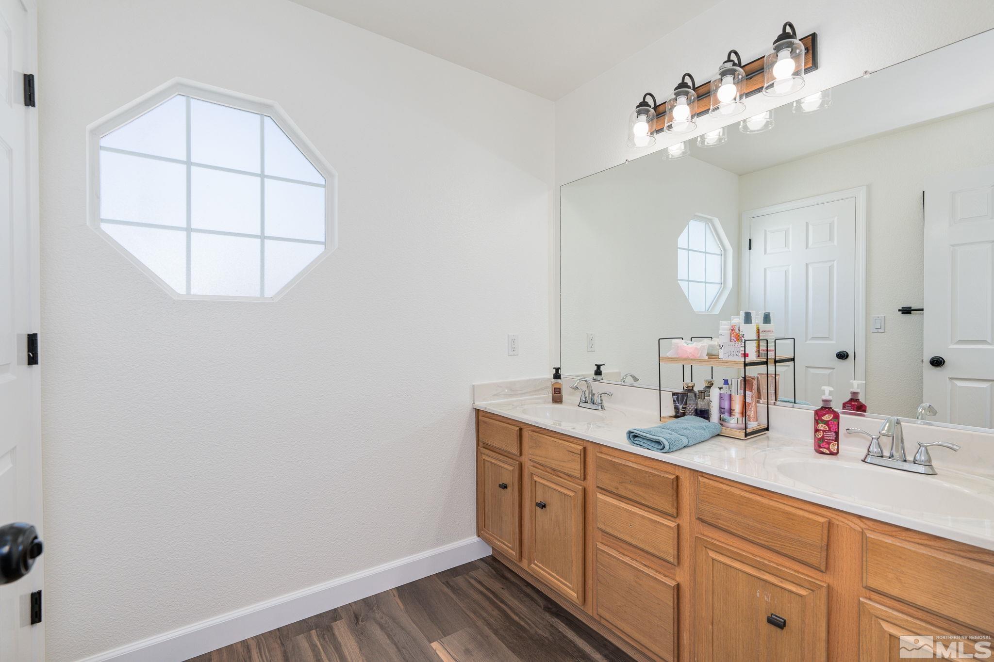 18198 Pin Oak Court Reno, NV 89508 - Photo 24 of 39 a bathroom with a double vanity sink and a mirror