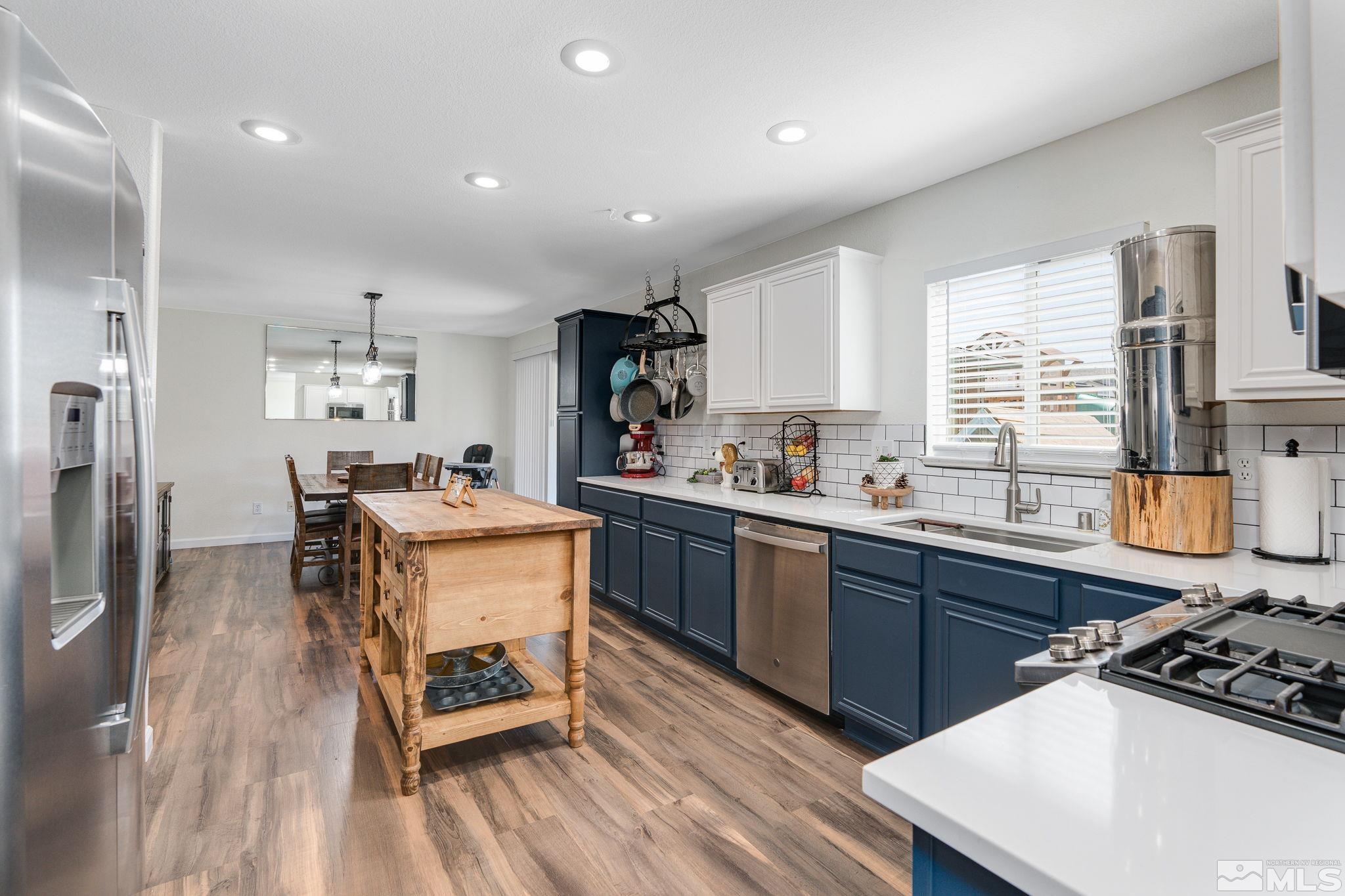 18198 Pin Oak Court Reno, NV 89508 - Photo 7 of 39 a kitchen with a sink appliances and cabinets