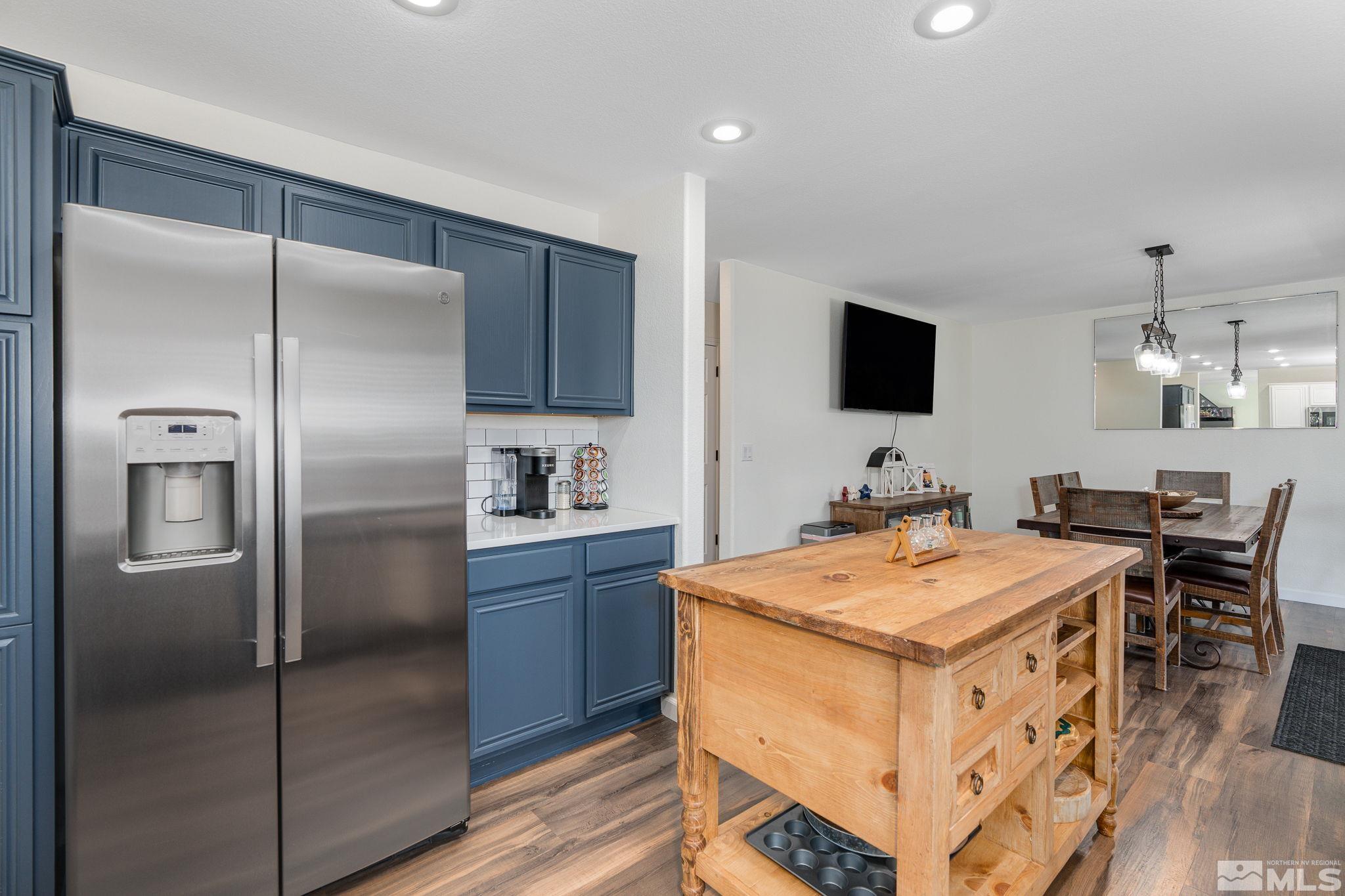 18198 Pin Oak Court Reno, NV 89508 - Photo 9 of 39 a kitchen with a refrigerator a table and chairs in it