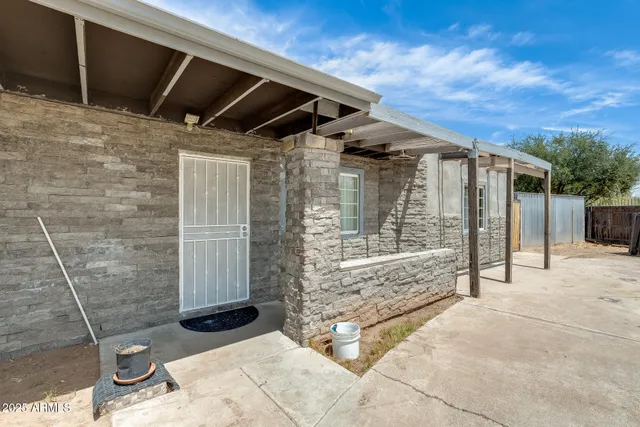 a view of a backyard with sitting area