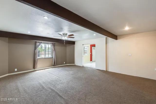a view of an empty room with a ceiling fan