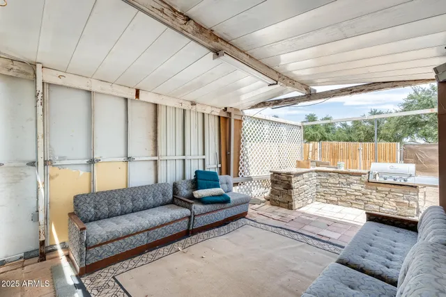 a view of backyard with wooden fence