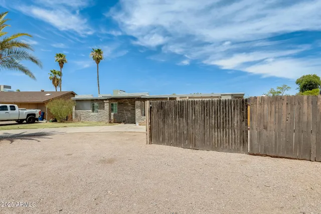 a view of a house with a yard and sitting area