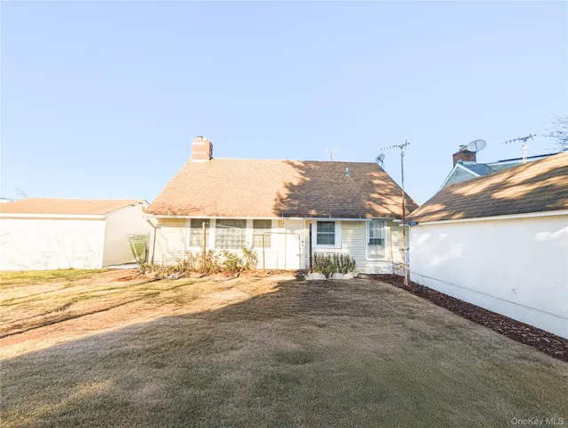 a view of a house with backyard and deck