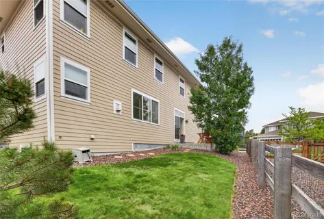 a view of a house with a small yard and potted plants