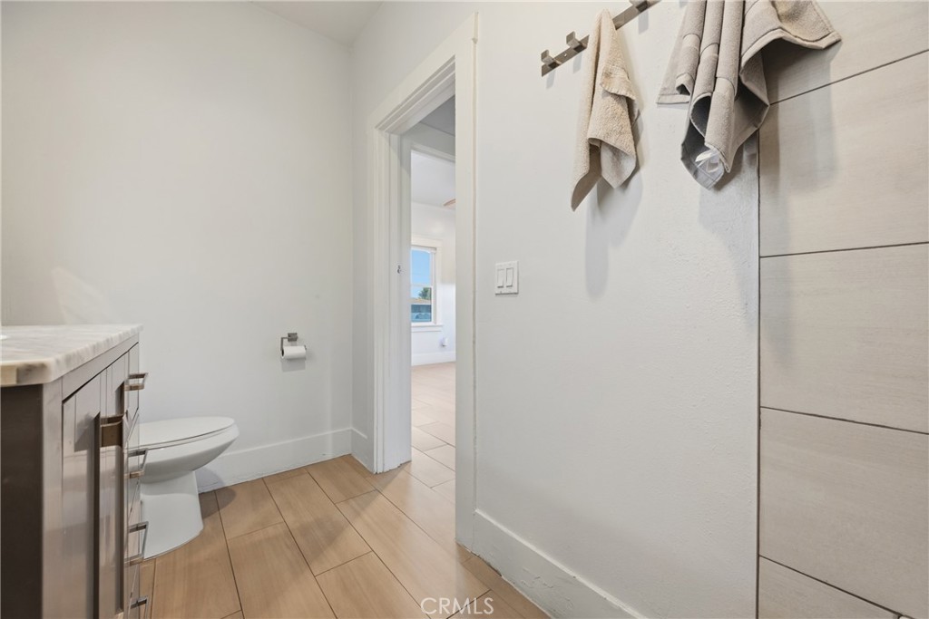 325 East 14th Street Long Beach, CA 90813 - Photo 18 of 21 a bathroom with a granite countertop shower and a toilet