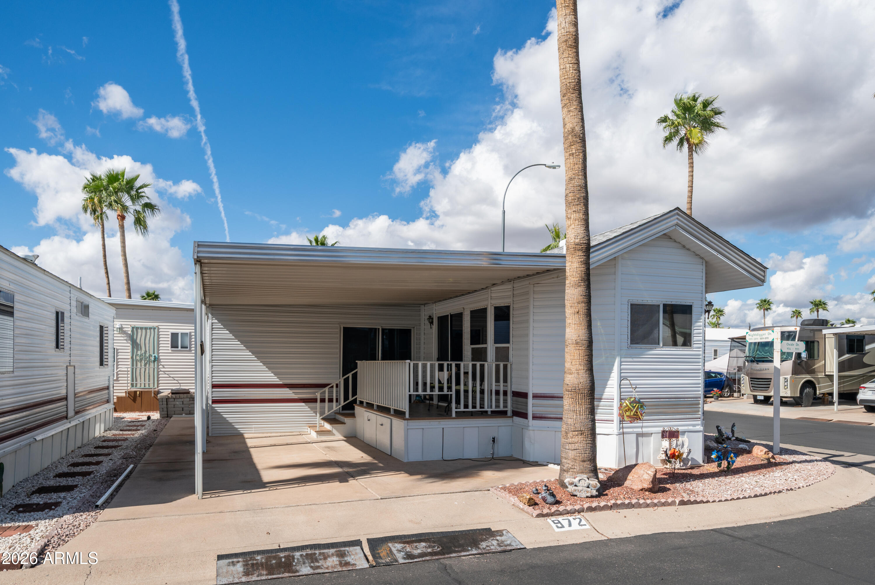 3710 South Goldfield Road, Unit 972 Apache Junction, AZ 85119 - Photo 1 of 60 a front view of a house with garden