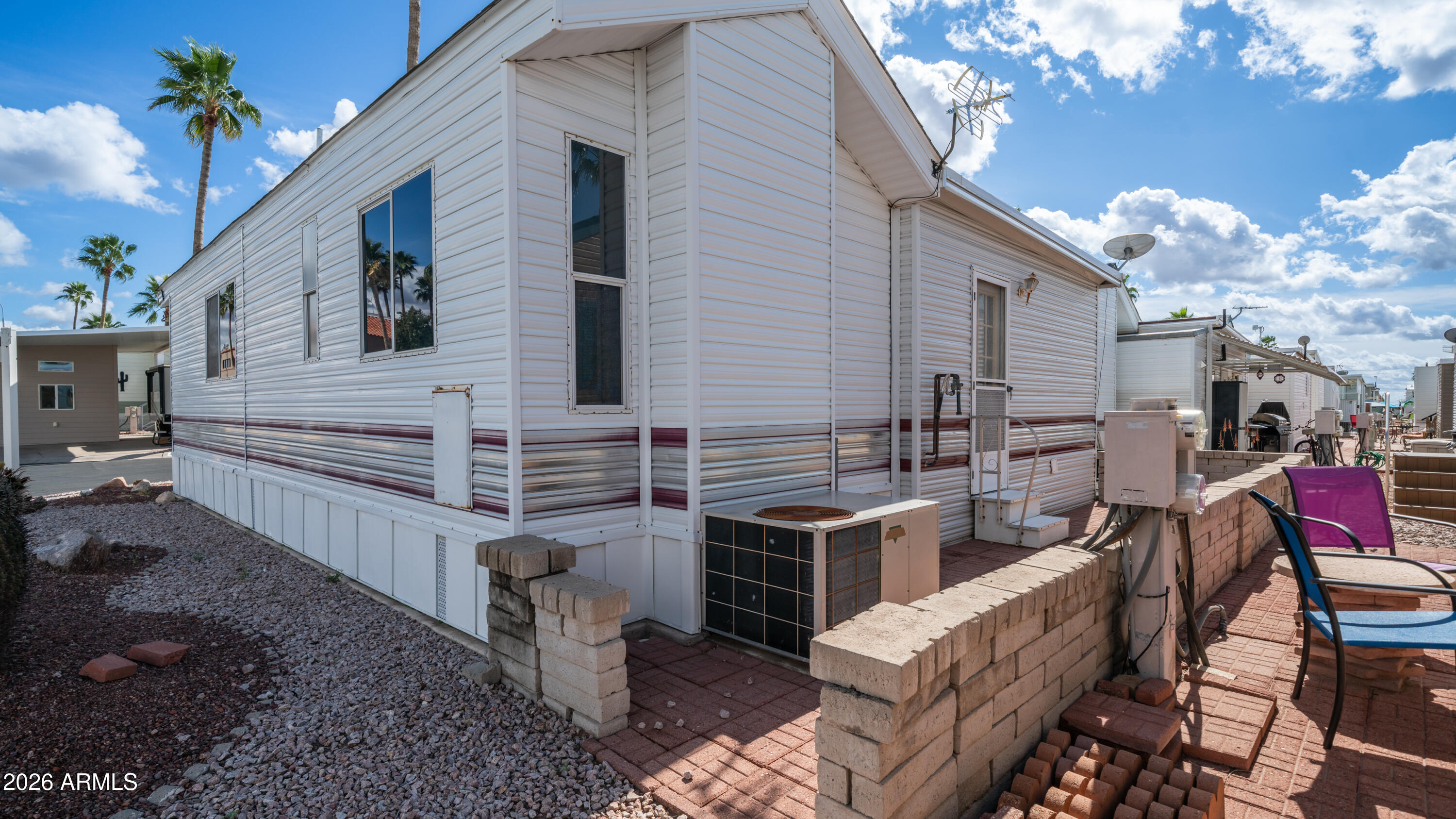 3710 South Goldfield Road, Unit 972 Apache Junction, AZ 85119 - Photo 13 of 60 a view of a house with backyard and sitting area