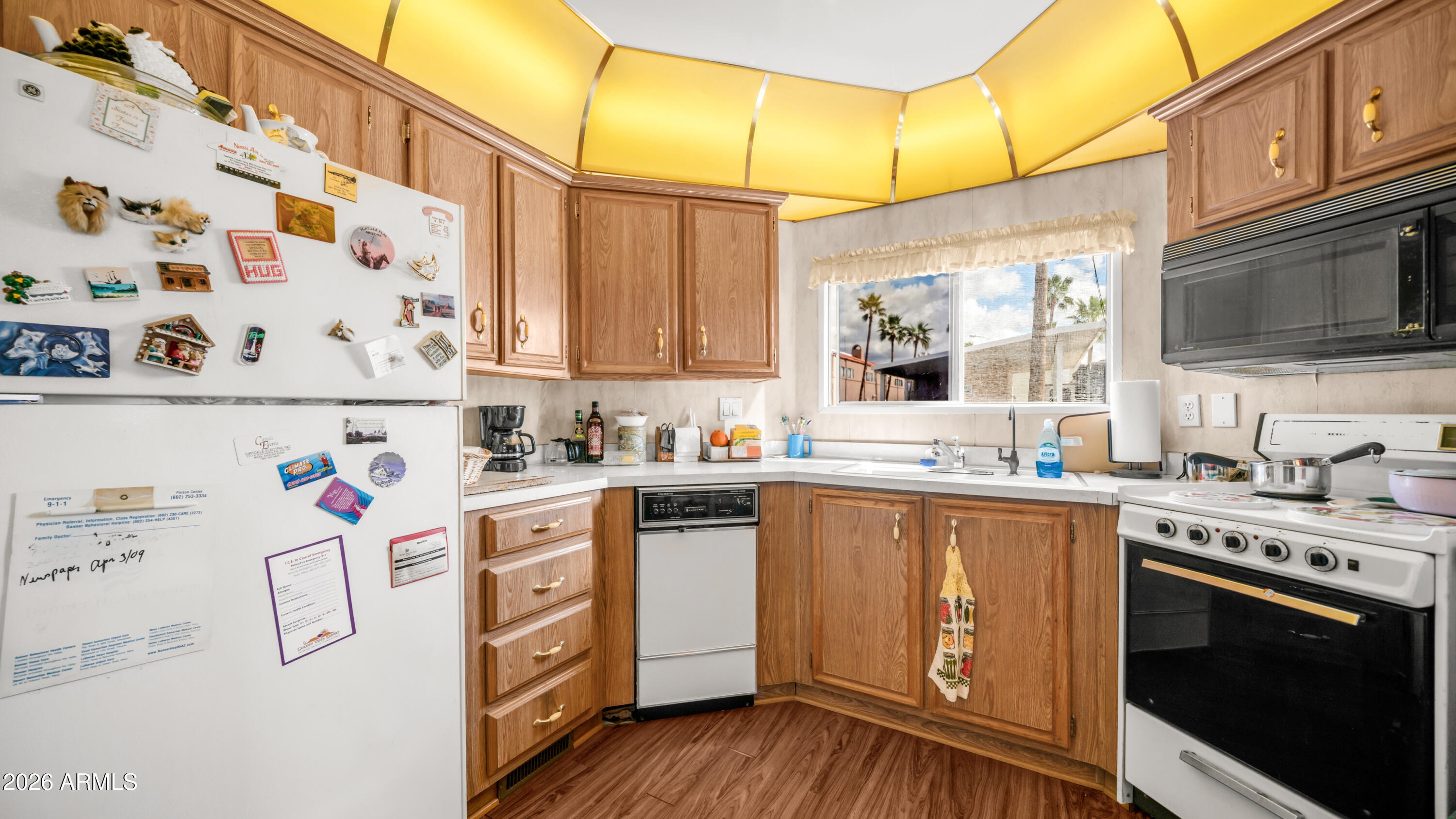 3710 South Goldfield Road, Unit 972 Apache Junction, AZ 85119 - Photo 15 of 60 a kitchen with stainless steel appliances a stove a sink and a refrigerator