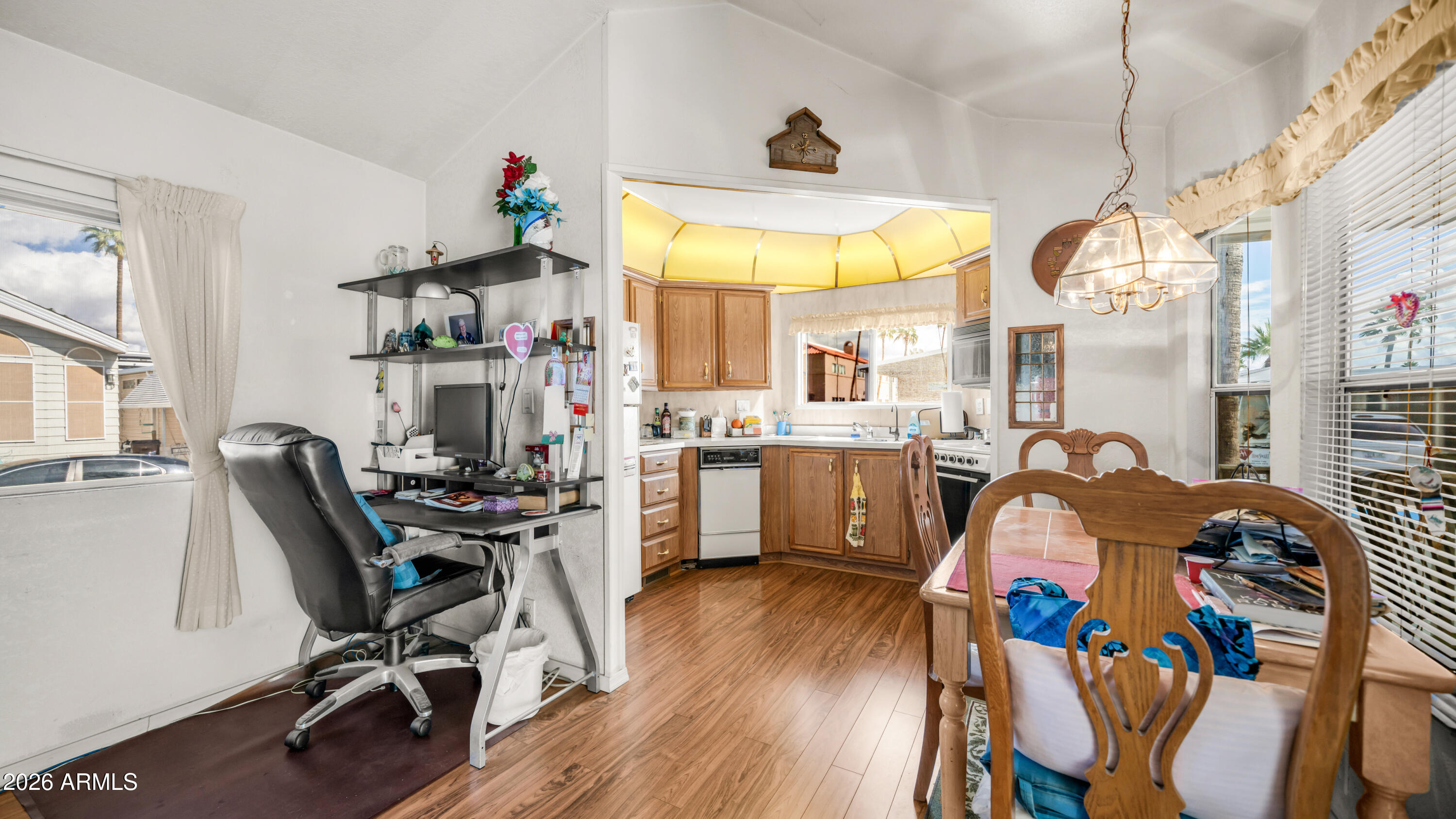 3710 South Goldfield Road, Unit 972 Apache Junction, AZ 85119 - Photo 17 of 60 a view of a dining room with furniture a chandelier and wooden floor