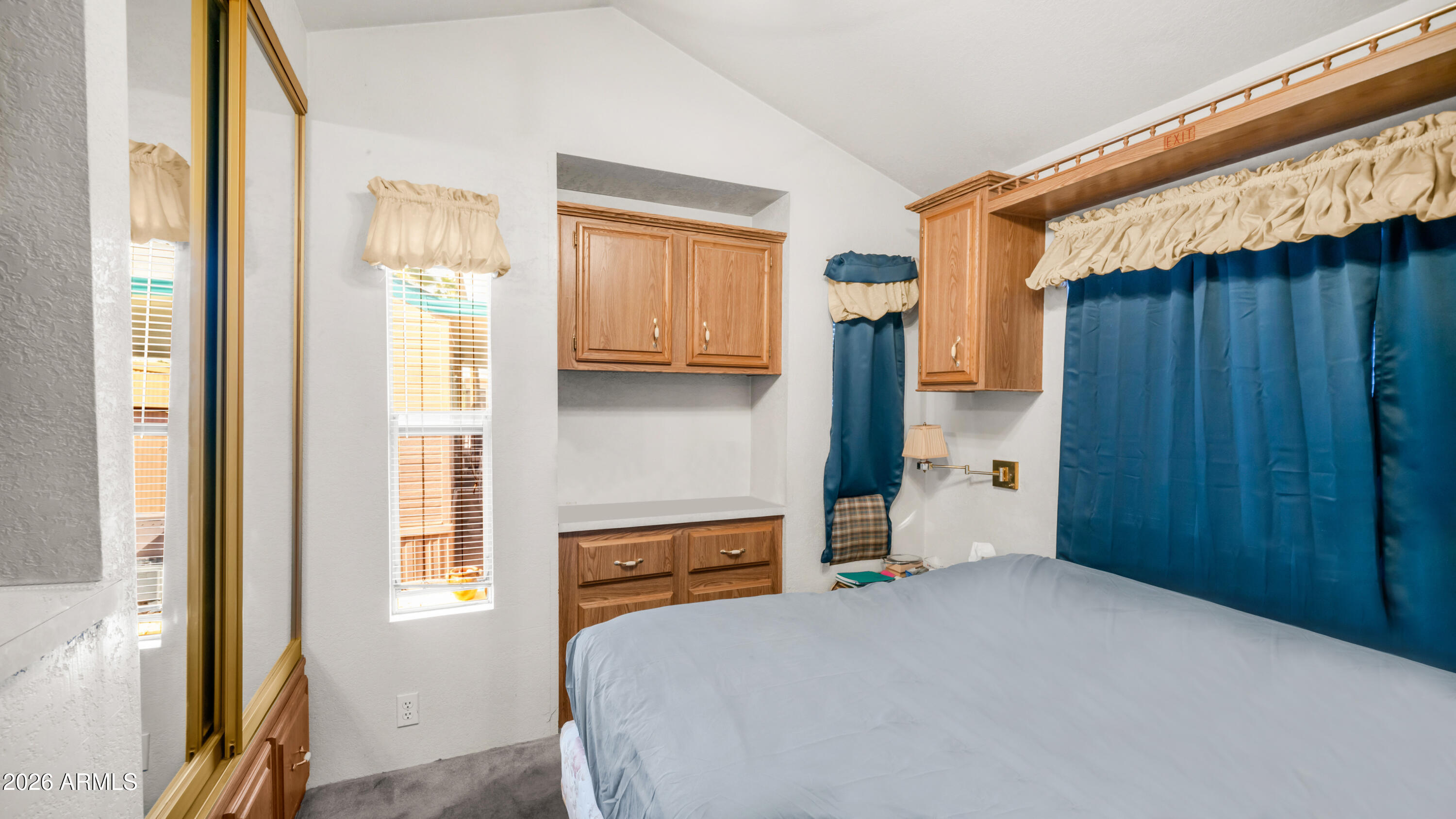 3710 South Goldfield Road, Unit 972 Apache Junction, AZ 85119 - Photo 23 of 60 a bedroom with a bed and a window