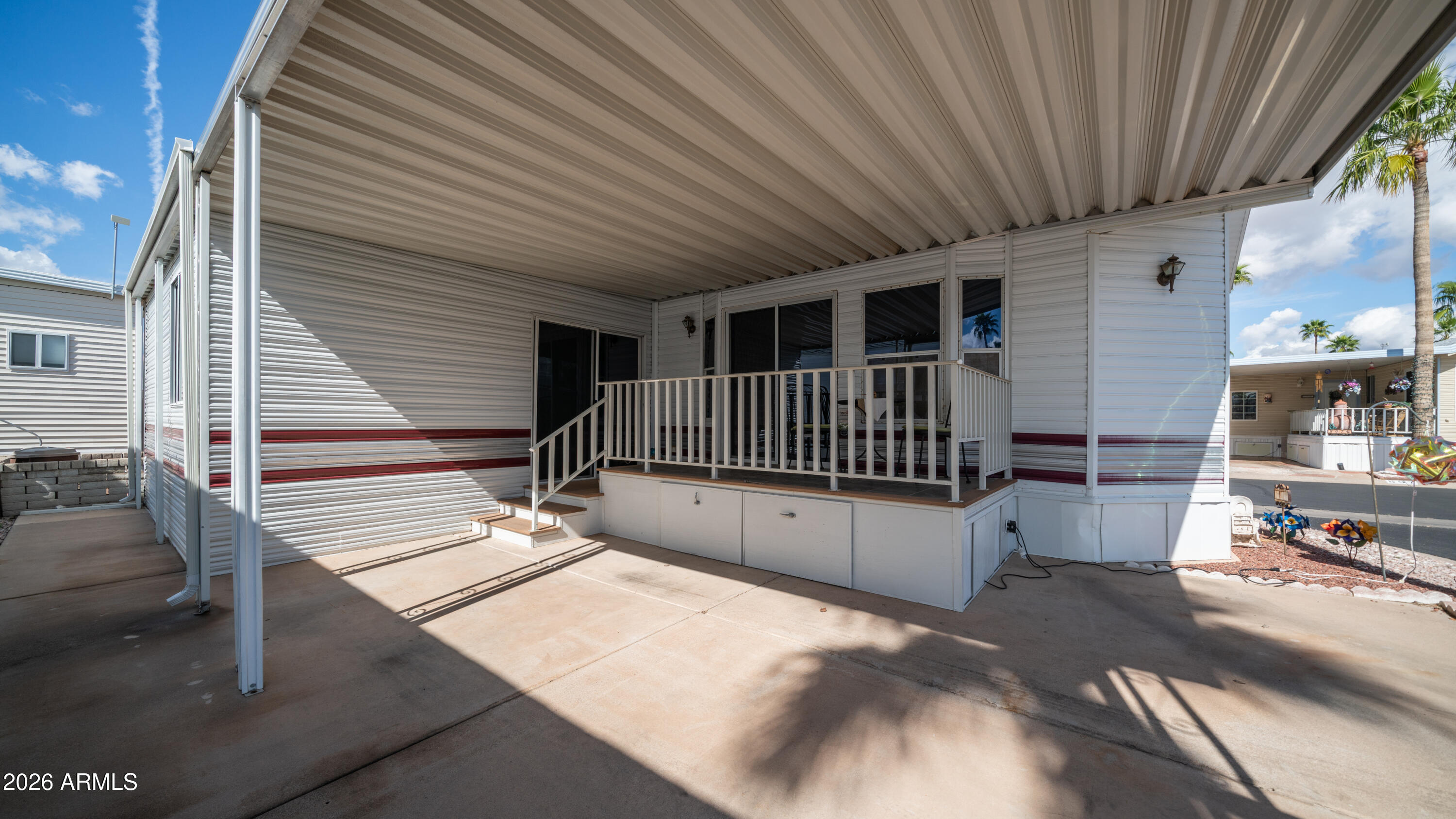 3710 South Goldfield Road, Unit 972 Apache Junction, AZ 85119 - Photo 6 of 60 a view of balcony with wooden floor and outdoor seating