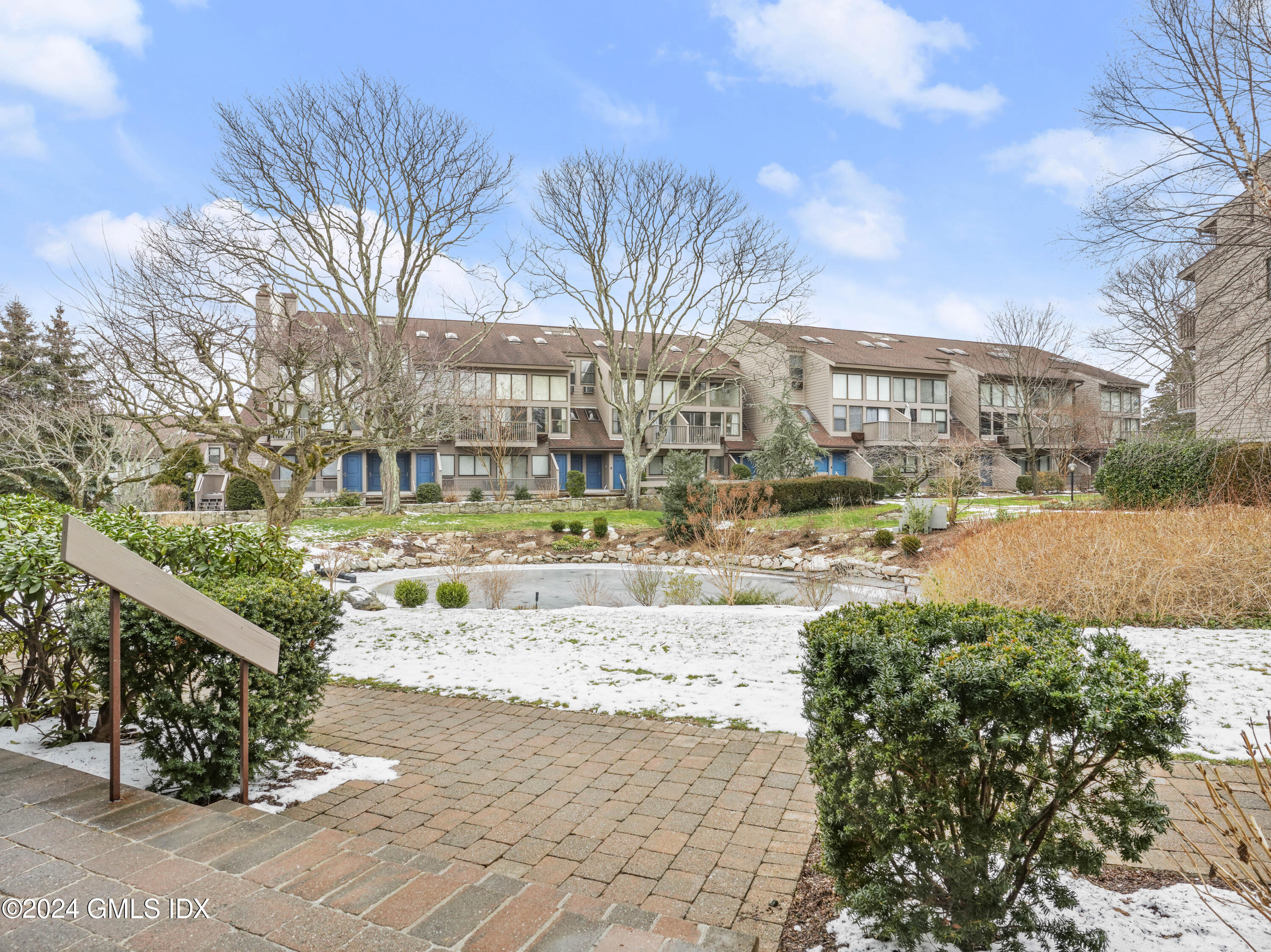 1465 East Putnam Avenue, Unit 312 Riverside, CT 06878 - Photo 1 of 13 Exterior with pond